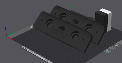 Two 3D printed rectangular brackets with circular cutouts on a digital print bed